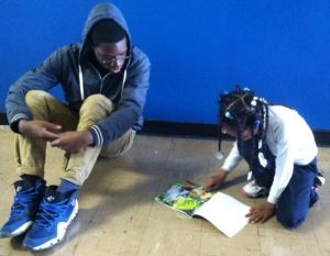 Kyare and his student, reading.